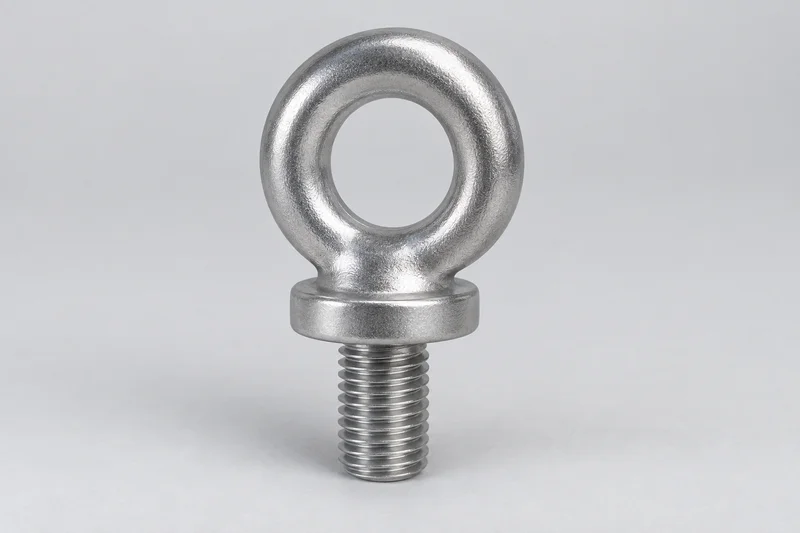 Reference illustration of a fixed eye bolt with a closed circular eye, broad shoulder and externally threaded shank.